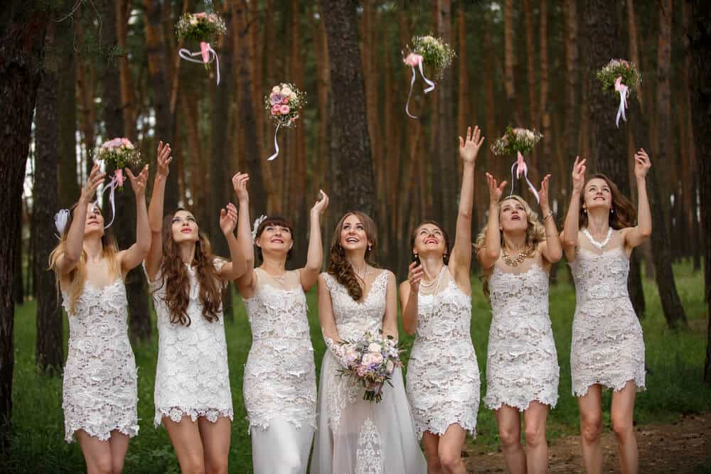 Bride and bridesmaids throwing wedding bouquets