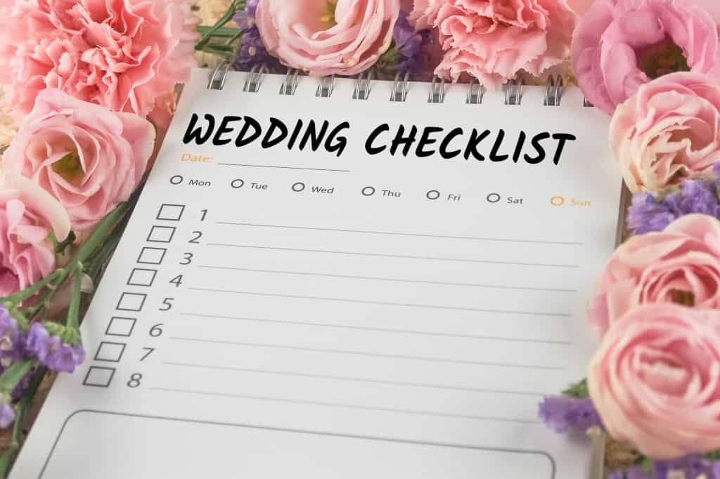 wedding checklist note paper on pink flower background