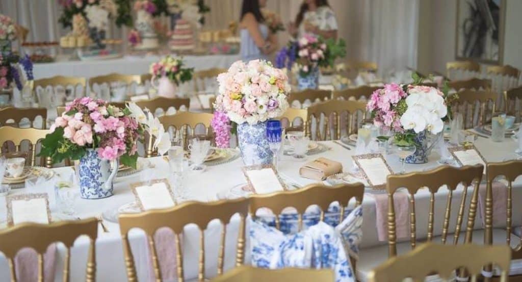 golden chairs and flowers high tea set up