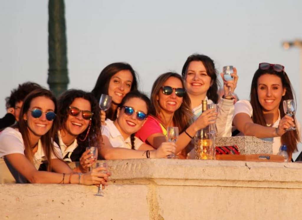 girls drinking along wall in madrid