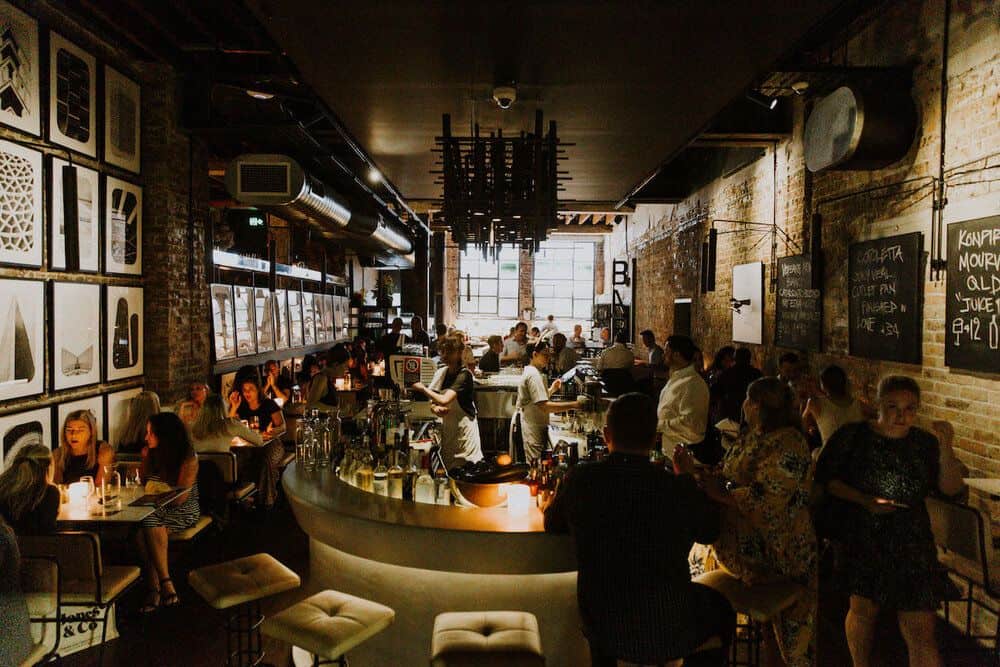 full house with bar in middle and dining chairs and tables