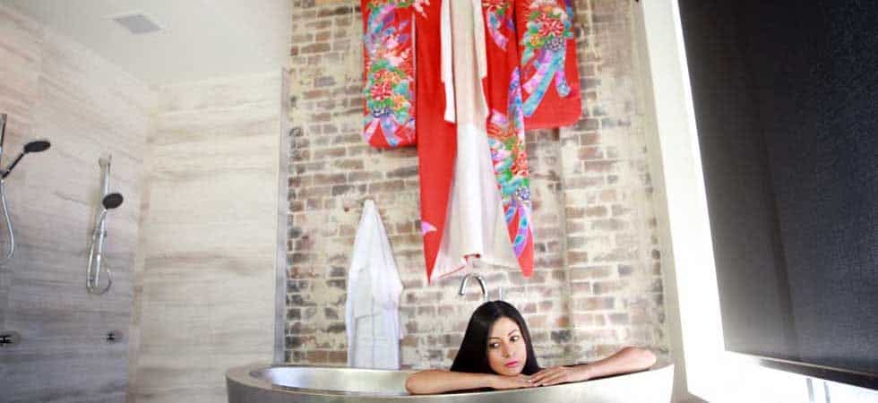 girl in bathtub with kimono in background