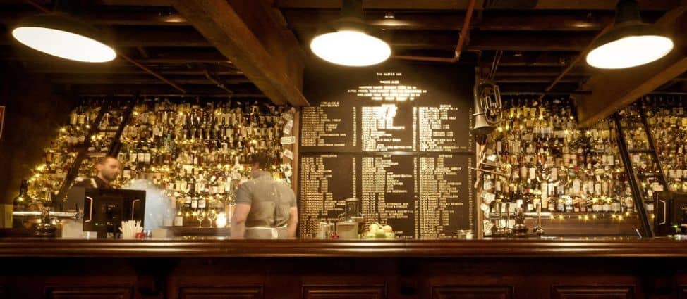 bar with large menu on wall