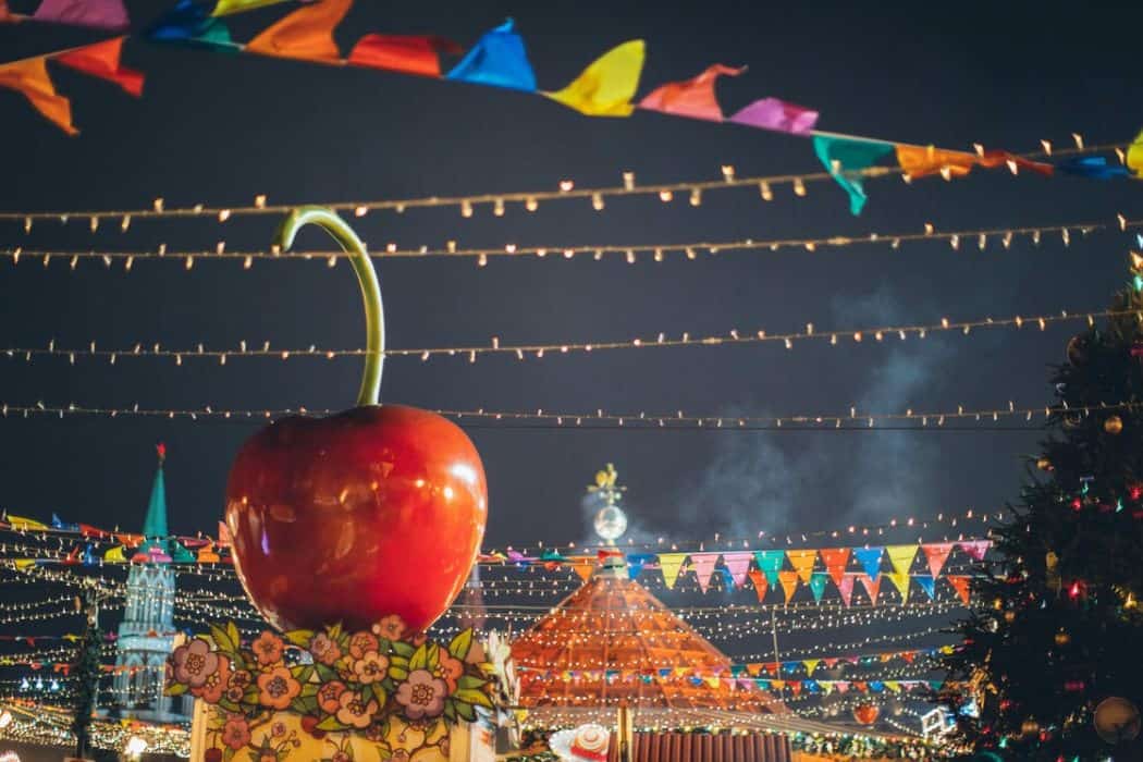 giant decorative apple on roof of stall on colorfu