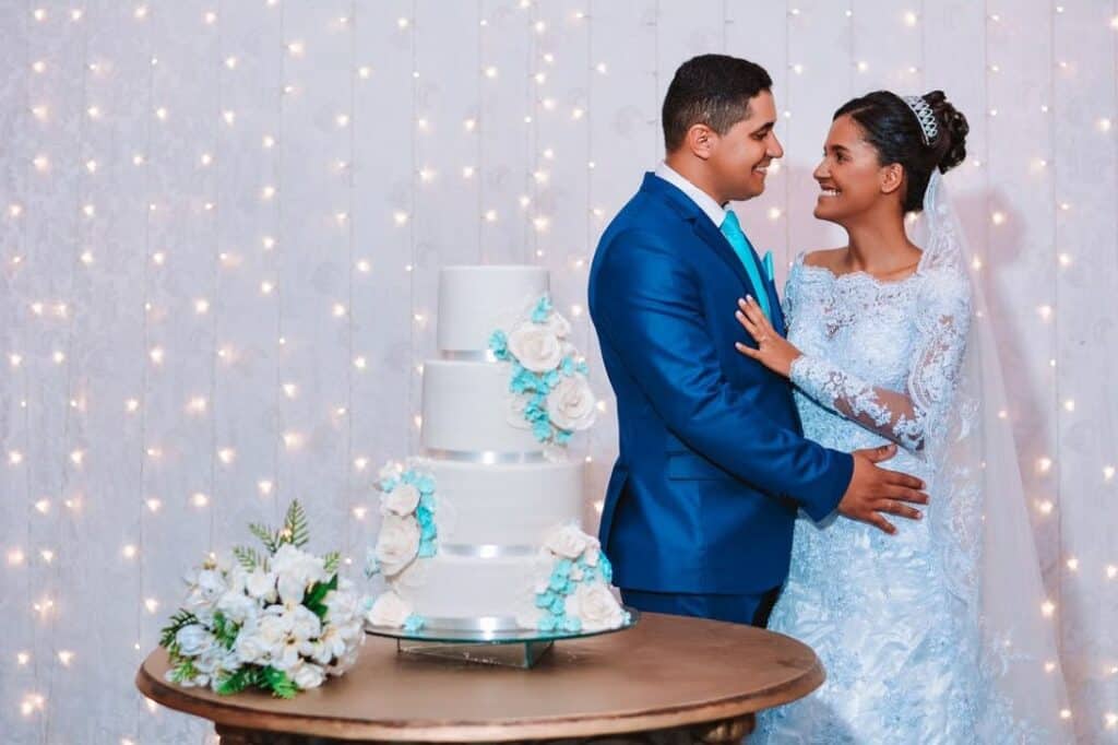 newlyweds standing beside their cake · free stock