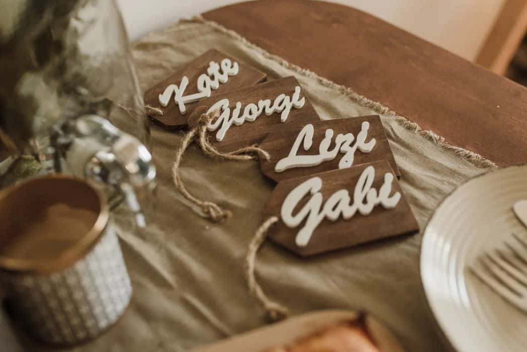 wooden name tags arranged on table during wedding
