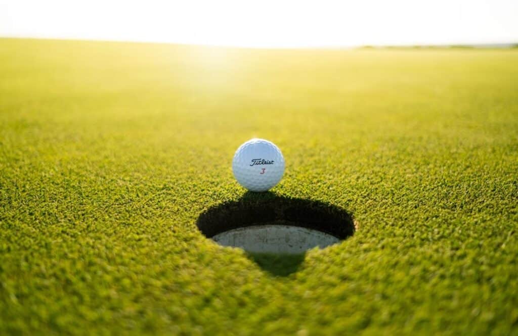 golf ball on green grass field during daytime phot