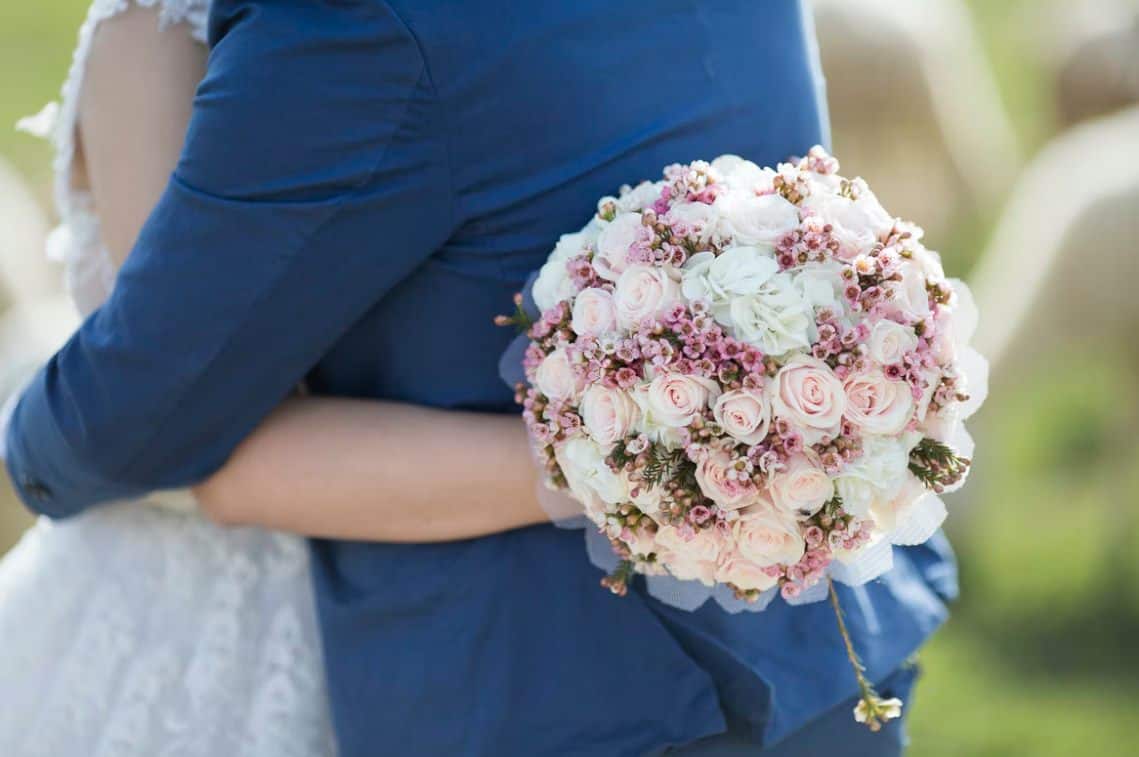 person holding rose bouquet photo – free wedding i