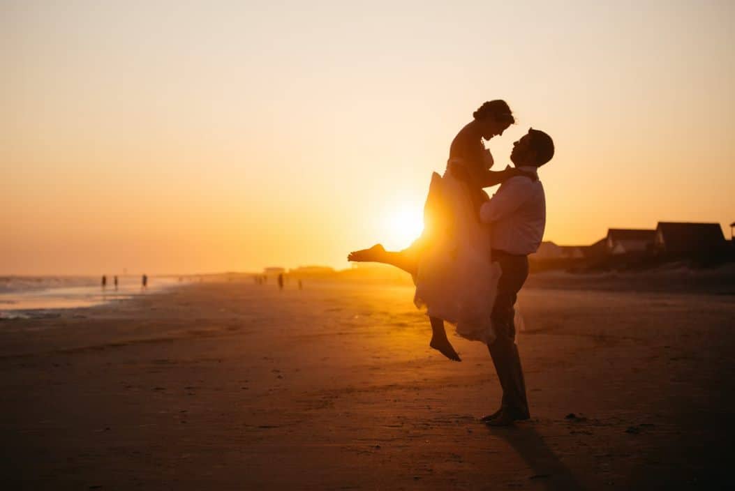 silhouette photo of man and woman on seashore phot