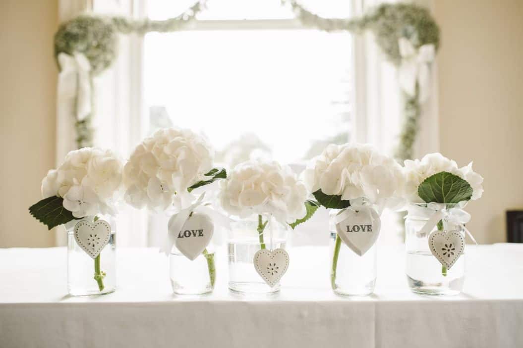 white flowers in glass jars photo – free wedding i